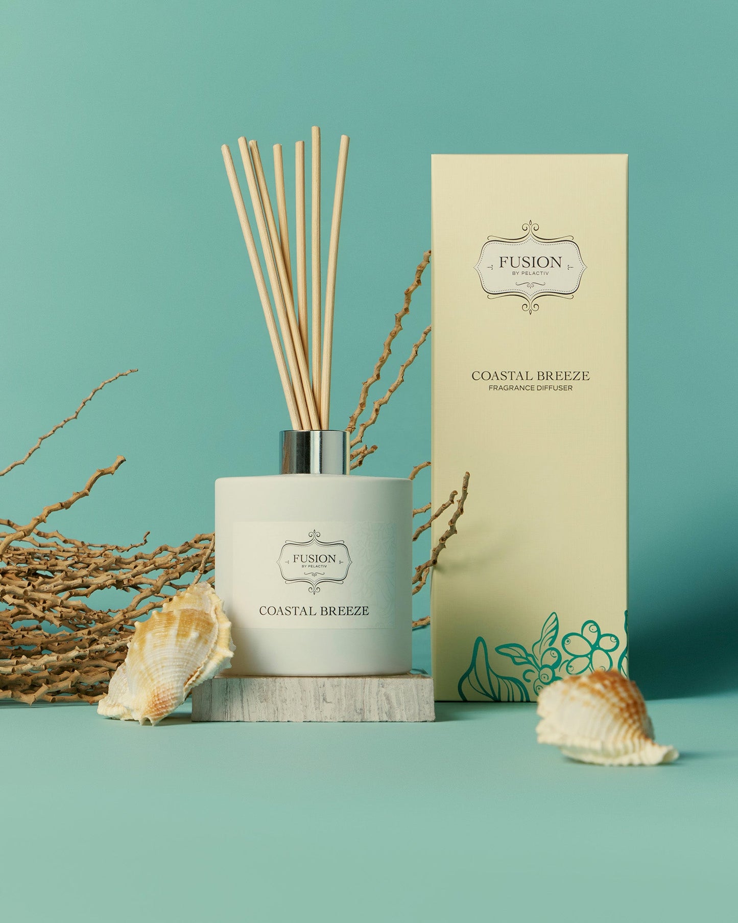 A reed diffuser is positioned next to a box adorned with a sea shell, enhancing a serene and beachy atmosphere.