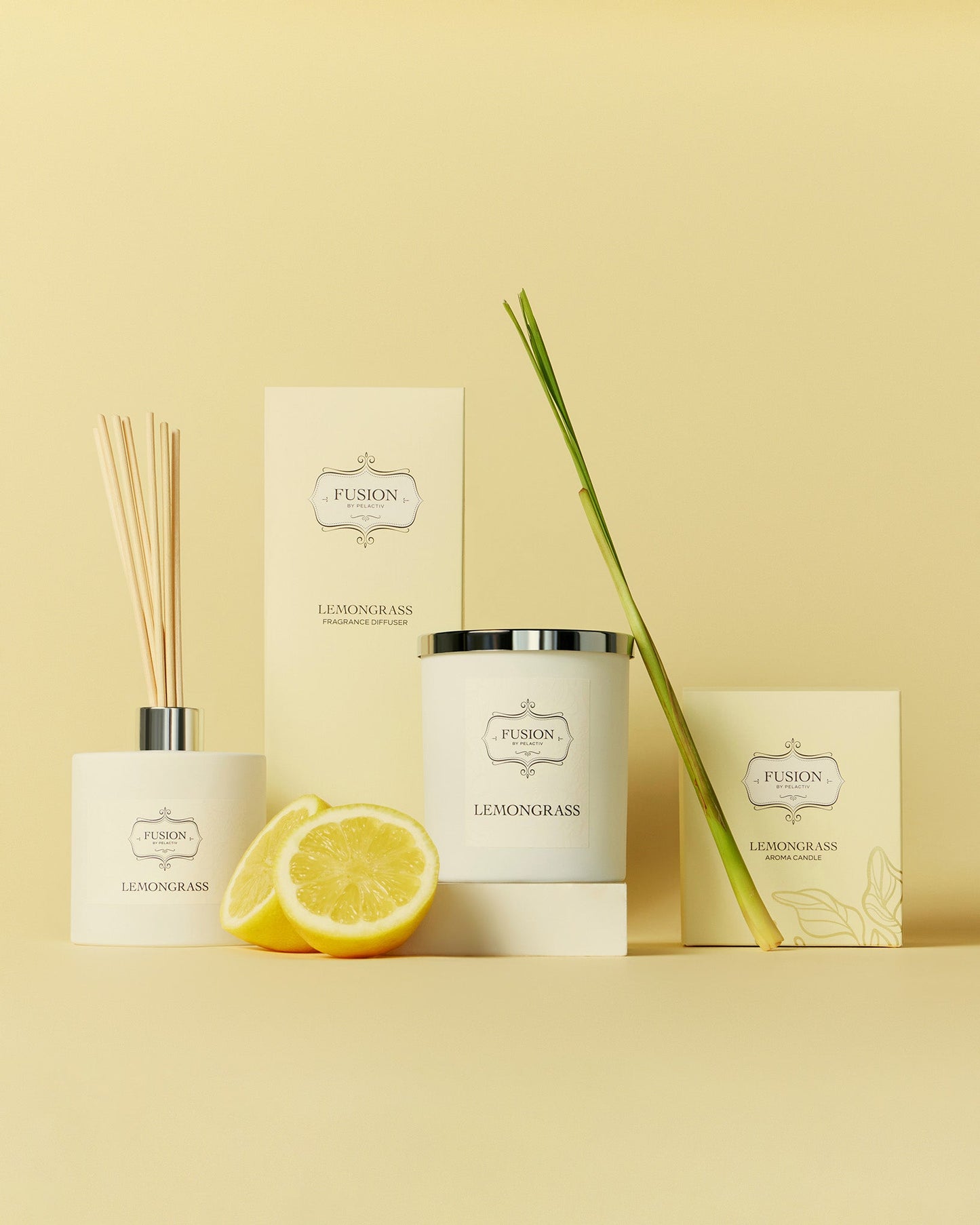 A colourful display featuring a lemon, shallot, a white glass jar candle, and a glass diffuser jar, highlighting a selection of diverse products on a muted yellow background.